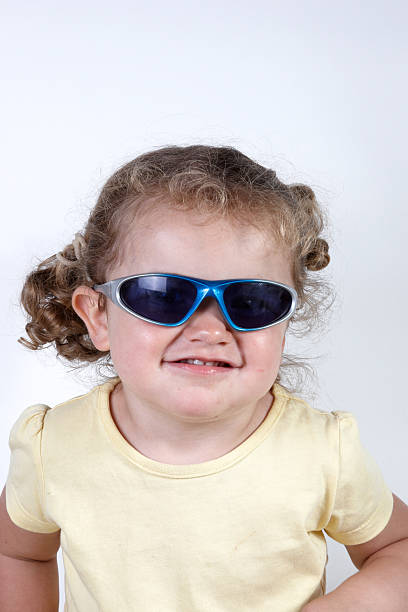istock Two year old girl portrait wearing sunglasses pulling funny face 136620730