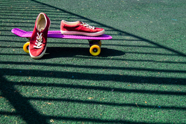 istock red sneakers on a pink skateboard 1366208182