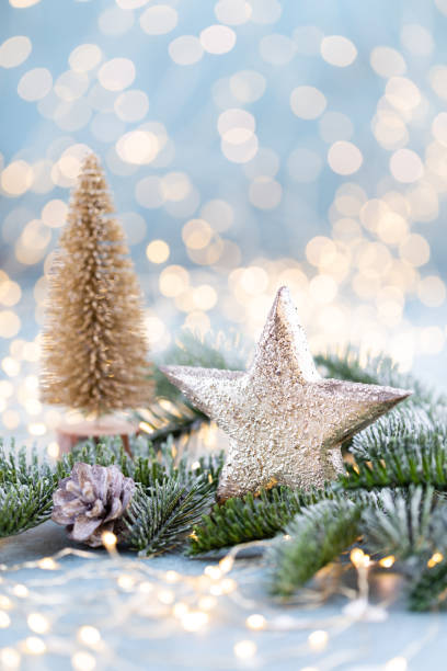 istock Christmas spruce with star and blurred shiny lights. 1366209749