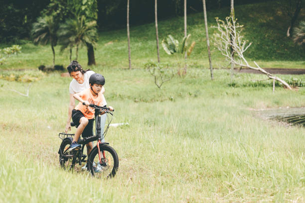 istock mother teaching son to ride a bicycle 1366211932
