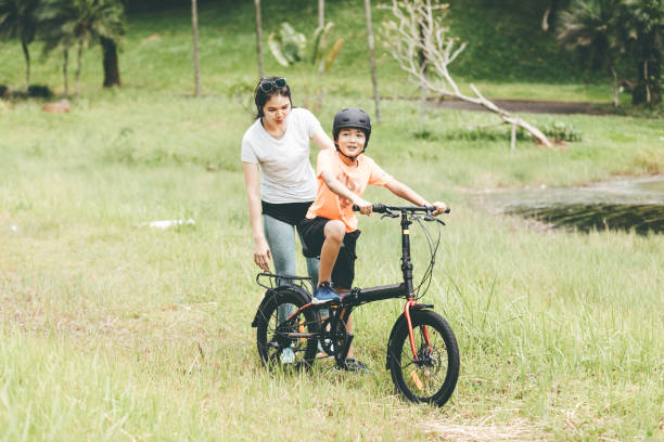 istock mother teaching son to ride a bicycle 1366211935