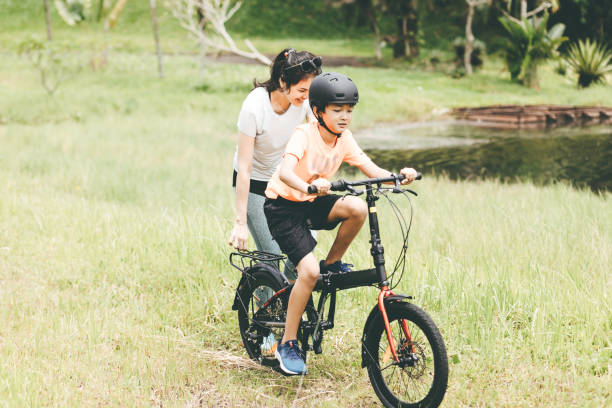 istock mother teaching son to ride a bicycle 1366211941
