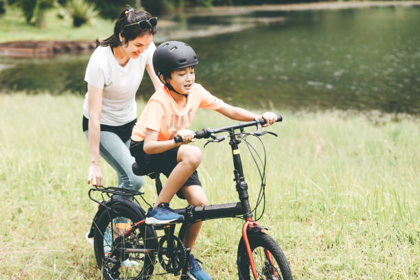 istock mother teaching son to ride a bicycle 1366211979