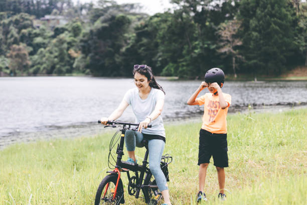 istock Playful mother with son  on her bicycle 1366212006