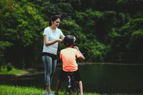 istock mother and son taking rest when riding on the forest 1366212061