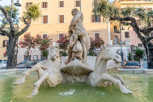 Nettuno, Rome, Italy, August 2021: The Fountain of Neptune, symbol of the city that bears the name of the pagan god of the sea, is located in Nettuno, in Piazza Mazzini,old town of Neptune