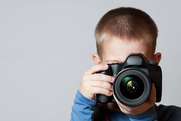 istock Little Boy holding camera and taking photo 136621422