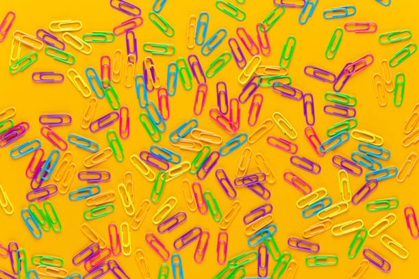 Paper color clip notebook on yellow background. Flat lay.
