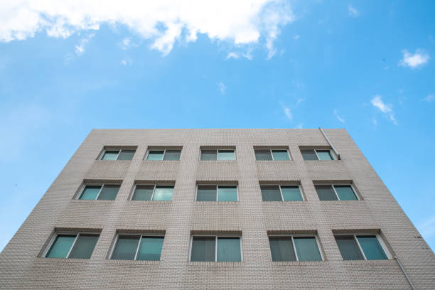 Looking up at a high building under the blue sky.