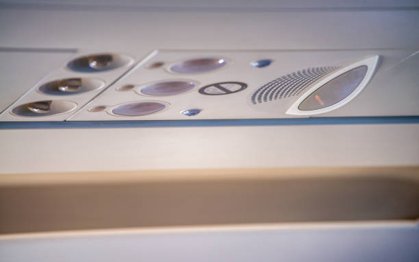 istock Typical passenger control panel above seats in airplane. Controls for air, lights and displays for seat belts and no smoking. 1366219712