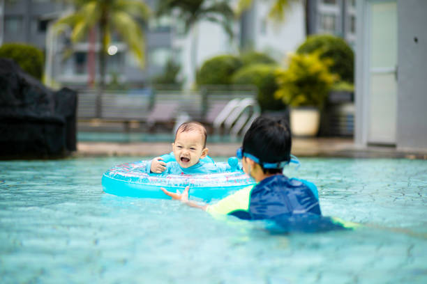 kid  and his young brother enjoy swimming