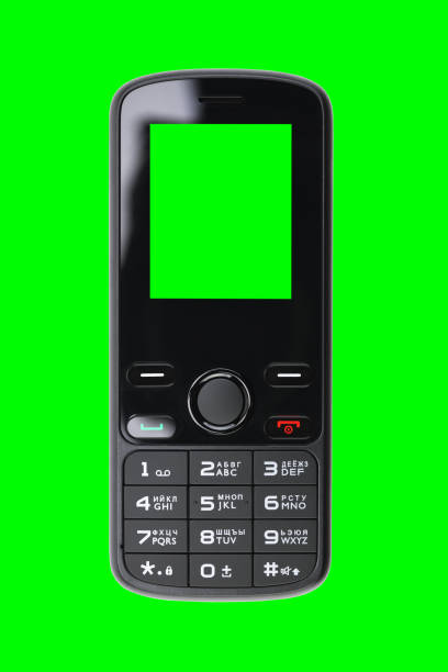 istock Retro push-button mobile phone isolated on a green background with a green screen. 1366224825