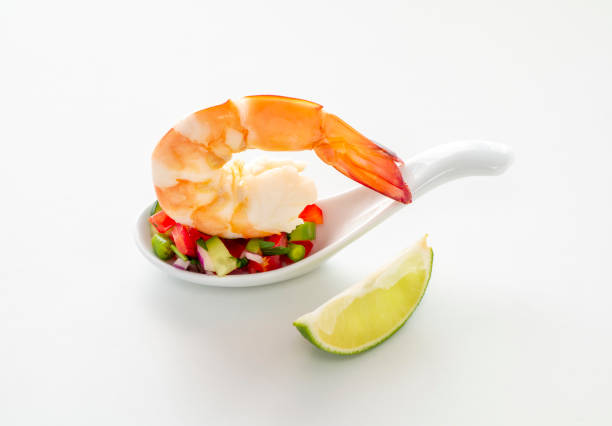 Peeled shrimps in a bowl isolated on white background