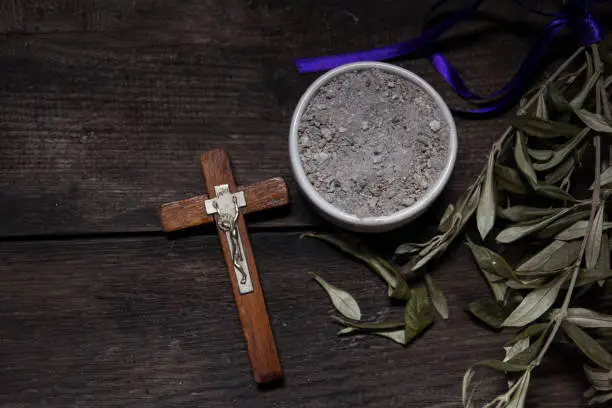 Photo of bowl with ashes and olive branch. ash wednesday concept