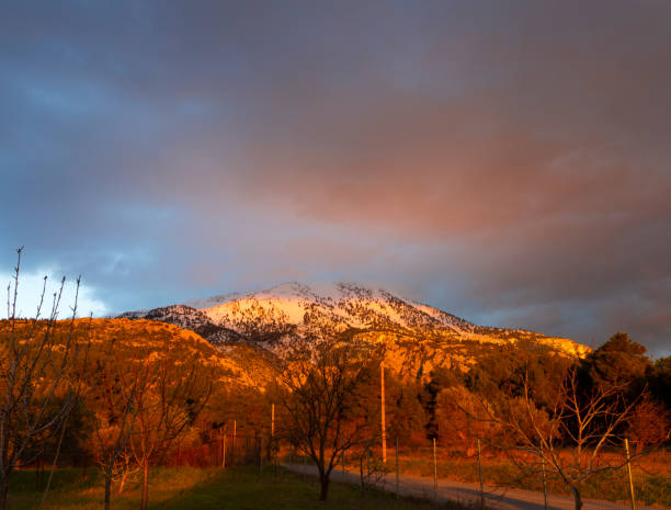 istock Panoramic view Snow-capped peaks of mount Dirfys spruce forest on a background of clouds on the island of Evia (Euboea) in Greece at sunset 1366229422