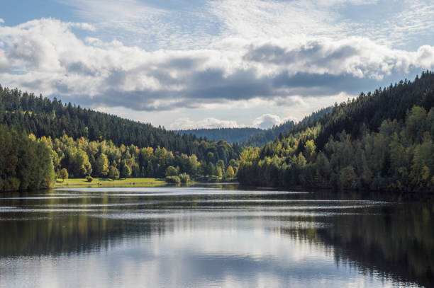 istock dam with blue sky and clouds on a beautiful day in fall with reflections on water 1366231276