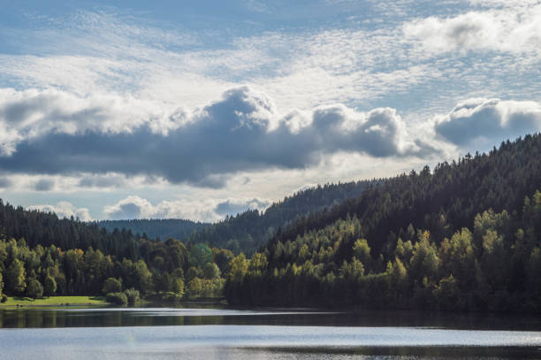 istock dam with blue sky and clouds on a beautiful day in fall with reflections on water 1366231577
