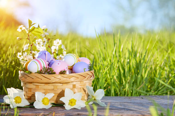 istock Basket with Easter eggs on a background of green grass. 1366233702