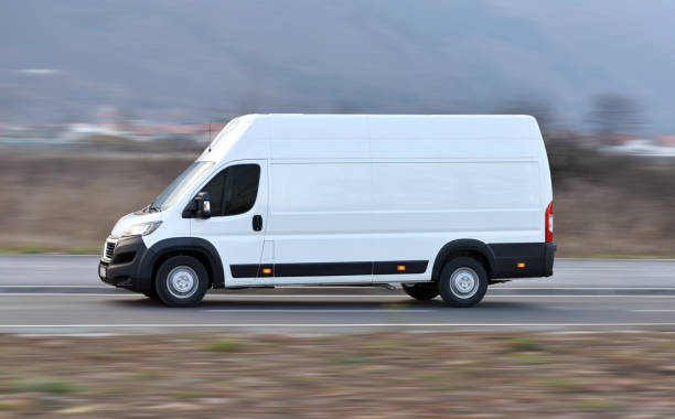 The large delivery van drives at high speed stock photo