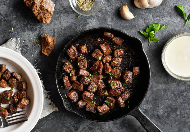 bocados de bistec con mantequilla de ajo - saute fotografías e imágenes de stock