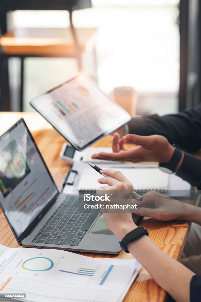 Business people team working at office with tablet and document, doing planning analyzing the financial report, business plan investment, finance analysis concept. Economic business discussions. Marketing Stock Photo