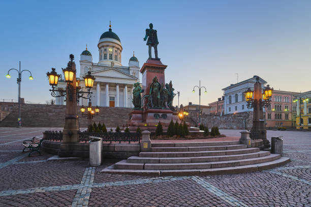 Monument to Emperor Alexander II and Cathedral of St. Nicholas in Helsinki. Monument to Emperor Alexander II created in 1894 and Cathedral of St. Nicholas in the Finnish capital city of Helsinki on the Senate Square Senaatintori: early morning, after dawn, around 6 am, empty, without people, clear sky. landscape arch photos stock pictures, royalty-free photos & images
