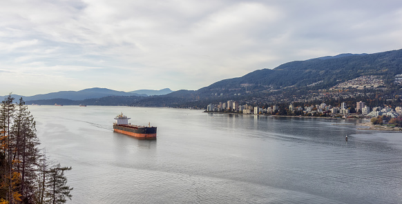 Aerial View of West Vancouver, Burrard Inlet and Container Ship. Taken from Lions Gate Bridge, British Columbia, Canada. Modern City on West Coast