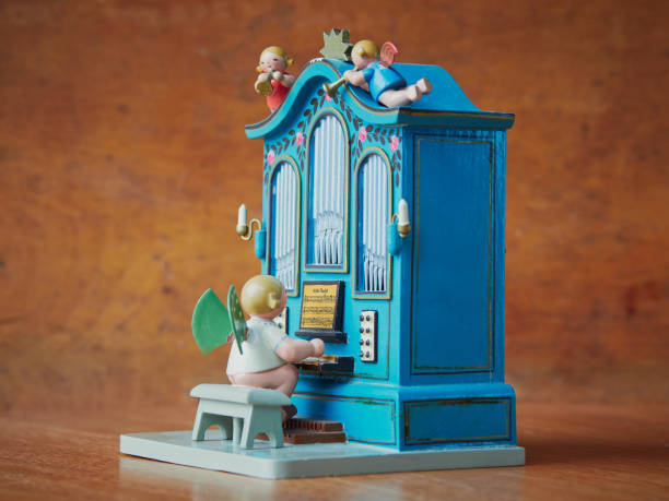 Old wooden musical Christmas toy Angel playing the organ.