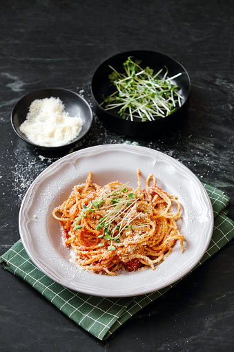 Creamy Ham Spaghetti. Close-up composition on dark background.