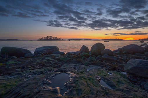 March evening in Finnish Kallahdenniemi: stones on the seashore, after sunset.