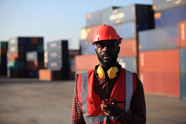 istock African American handsome black engineer he is working in container box yard area of  logistics transportation import export or shipping industry 1366240052
