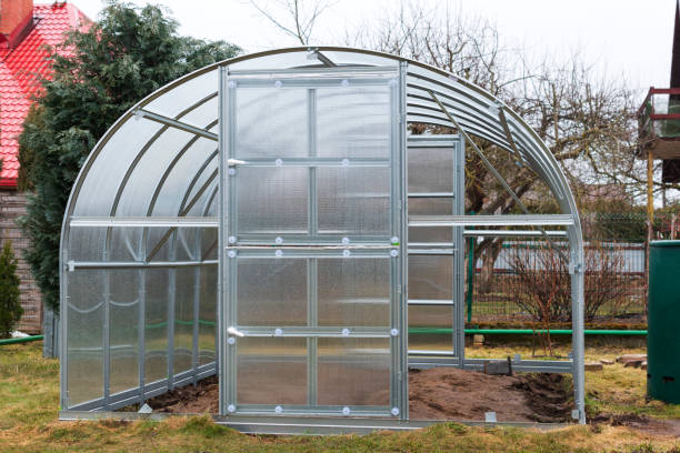 istock Side view of unfinished aluminum structure of polycarbonate greenhouse outdoors in spring. 1366240101