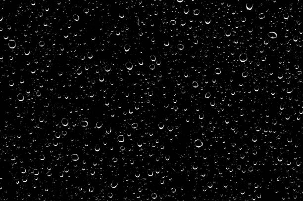 Water drops on glass transparent in black color. Water drops on glass transparent in black. raindrop stock pictures, royalty-free photos & images