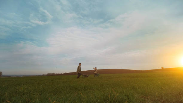 istock The father and son are going to work at the field 1366241517