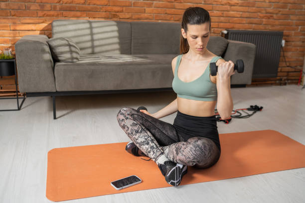 istock Fit woman exercising with dumbbells 1366244427