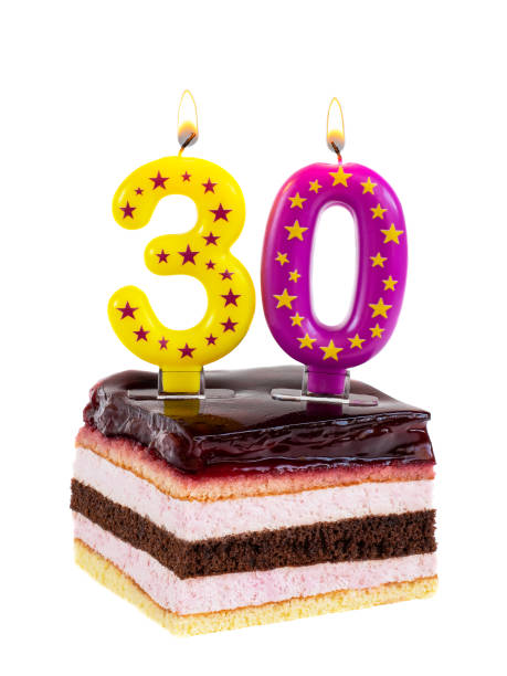 праздничный торт с горящими свечами к 30-летию - cake yellow sweet food banquet стоковые фото и изображения