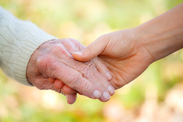 istock Senior and young holding hands 136624972