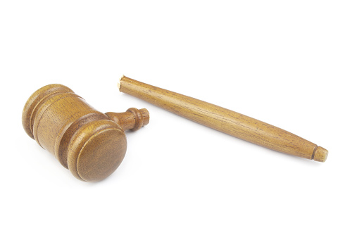 Broken wooden judge gavel isolated on white background. Concept of iniquity, injustice and lawlessness.