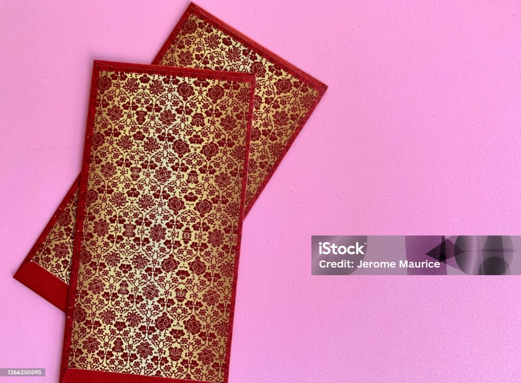 Dark red and golden color Chinese New Year envelopes with pink background. Chinese New Year Concept. Dark red and golden color Chinese New Year envelopes with pink background. Abundance Stock Photo