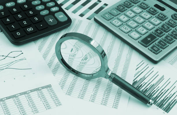 istock Business concept with magnifying glass, calculators and financial documents 1366250842
