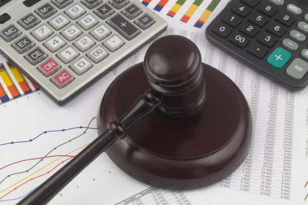 istock Arbitration concept, wooden judge gavel and calculators on financial documents. 1366250994