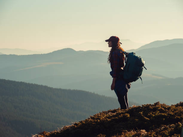 istock Hiker Woman with Backpack on Top of a Mountain 1366251043