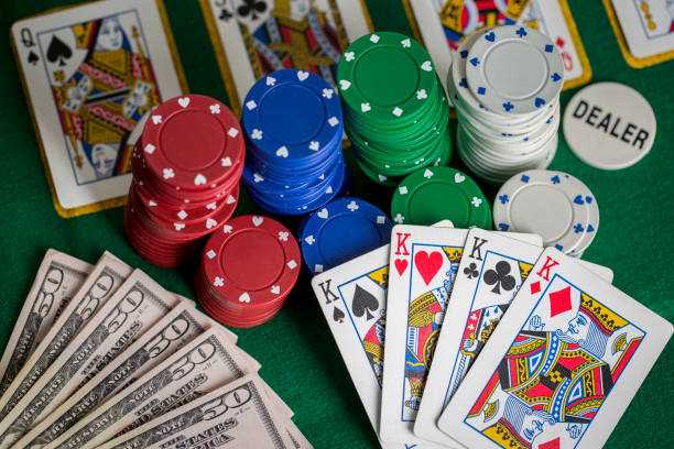 istock Poker concept with cards, gambling chips and money on green table 1366251049