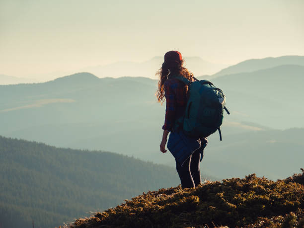 istock Hiker Woman with Backpack on Top of a Mountain 1366251061