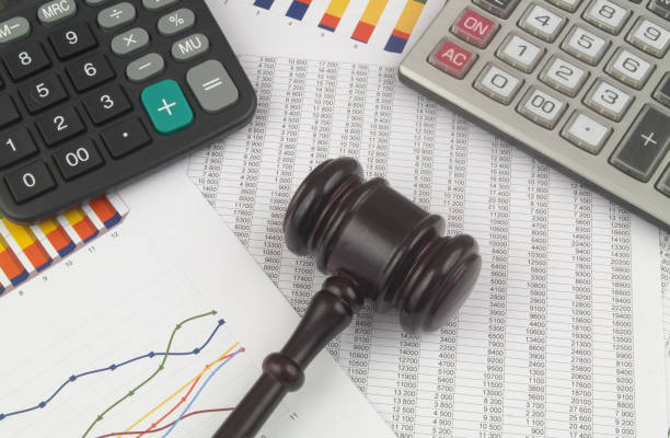 istock Arbitration concept, wooden judge gavel and calculators on financial documents. 1366251792