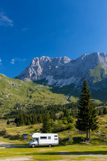 istock Caravan in summer mountain landscape, Alps, Italy 1366251943