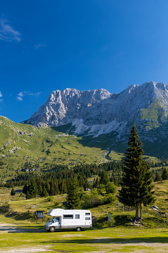 Caravan in summer mountain landscape, Alps, Italy