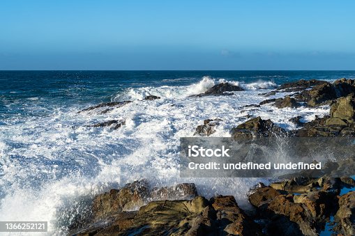 istock Waves Crashing on Rocks 1366252121