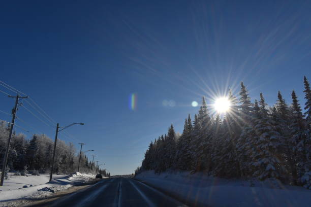 Un ciel bleu A country road in winter, Quebec, Canada ciel bleu stock pictures, royalty-free photos & images