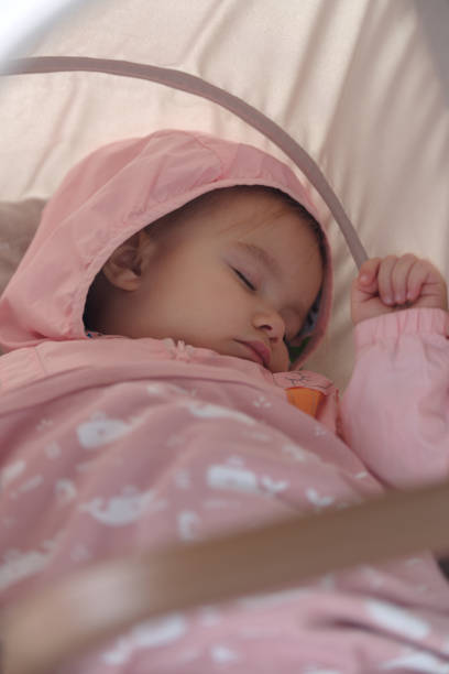 Baby girl sleeping in baby stroller outdoor